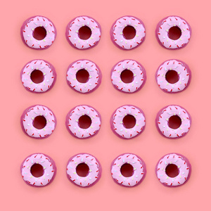 许多小的塑料甜甜圈位于柔和多彩的背景上。平躺最小模式。顶部视图