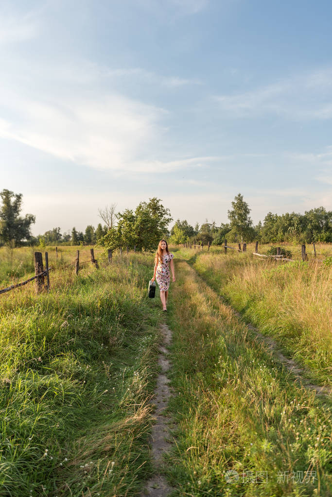 一个年轻的女人穿着一条粉红色的连衣裙, 上面有一