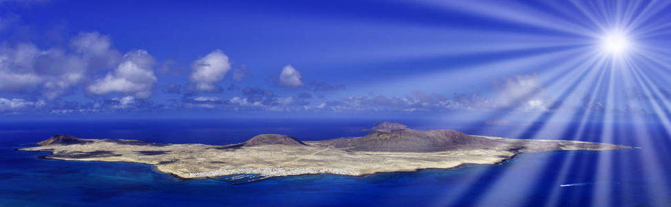 大西洋上的火山岛 La Graciosa, 可见的太阳射线从兰萨罗特, 西班牙加那利群岛的看法