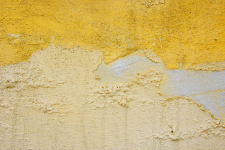 背景的黄色的灰泥涂和画外，粗糙水泥和混凝土墙体纹理的铸装饰涂料