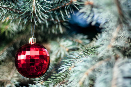 明亮的圣诞装饰品在圣诞树的树枝上。选择性对焦。戏剧性的光