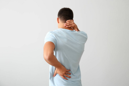 椎体疼痛年轻的人遭受背部疼痛的光背景照片
