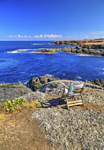 美丽的风景与木椅子在岩石海岸