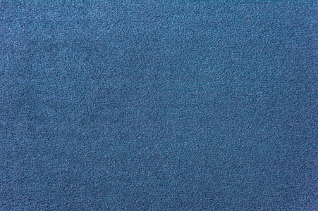 深蓝色地毯的质地.渐变光的特写照片