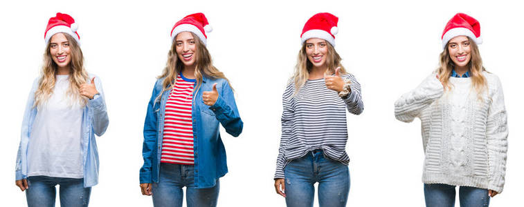 年轻美丽的年轻女子戴着圣诞帽在白色孤立的背景做快乐的大拇指与手的手势。通过显示成功来批准镜头的表达