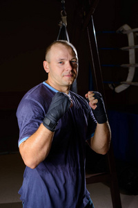 初学者拳击手肖像在冲压袋在一个黑暗的背景