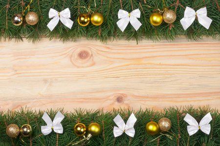 圣诞框架作出了冷杉的枝条装饰着白色的弓和黄金球轻木背景上
