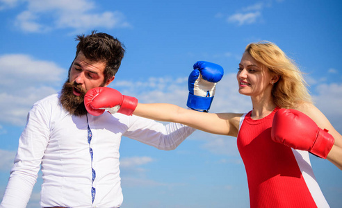 关系作为奋斗的理念.男人和女人打拳击手套蓝天背景.