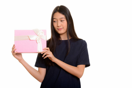 年轻美丽亚洲少女猜测礼品盒