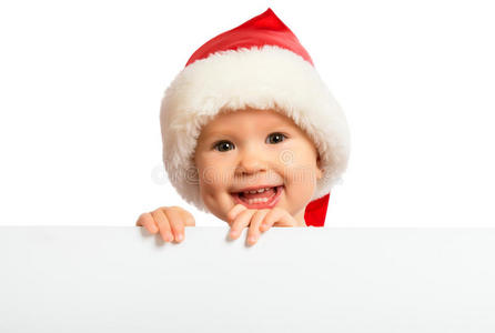戴着圣诞帽的快乐宝贝和一块被隔离的空白广告牌