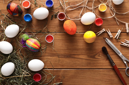 绘画多彩的复活节鸡蛋背景，在木头上的顶视图