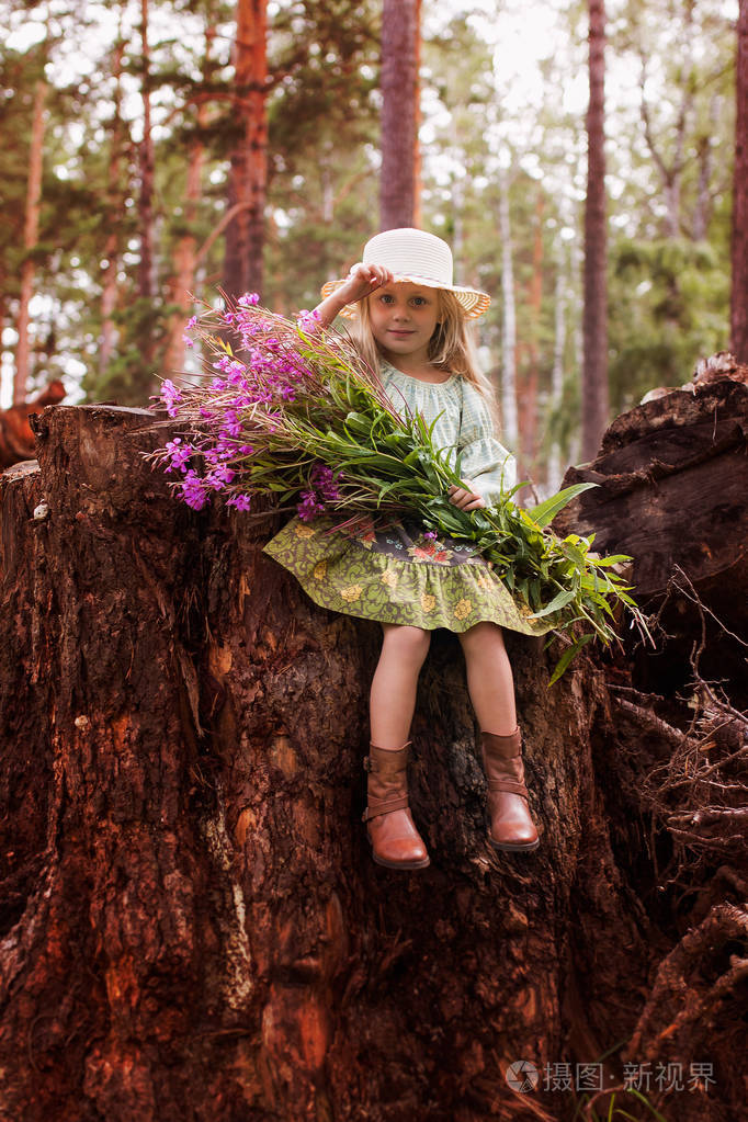 一束鲜花在森林里的一个夏日可爱的小女孩