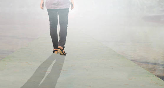 背面的妇女腿轻如梦幻般的长途径中走向照片