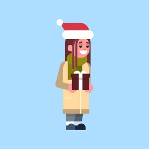 女孩圣诞老人红色帽子举行礼品盒目前快乐的圣诞节快乐新年概念女性卡通人物全长平