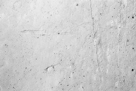 水泥背景的开裂表面。老灰色混凝土墙体的凸起质感