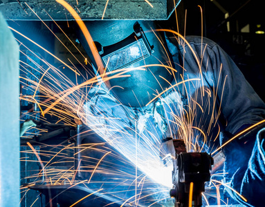工人用保护面罩焊接金属, 了解采取的行动气体焊接汽车行业