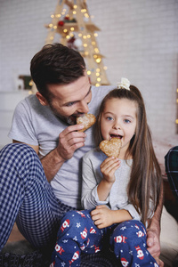 父亲和女儿在圣诞节吃姜饼