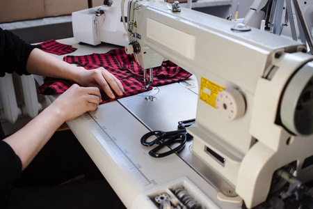 裁缝在缝纫机上工作.手.关闭.剪裁.详细照片