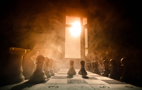 国际象棋棋盘游戏概念经营思路和竞争与战略思想概念。黑色背景与烟和雾的国际象棋棋子。选择性的焦点。手放在船上图