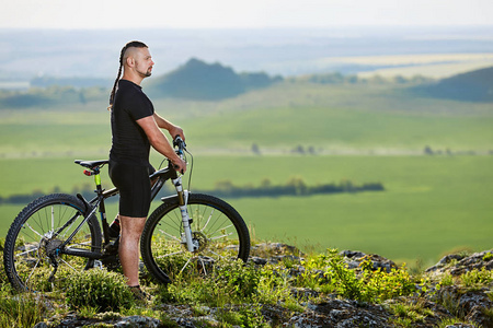 骑自行车的人站在一起的美丽风景的背景上的山地自行车