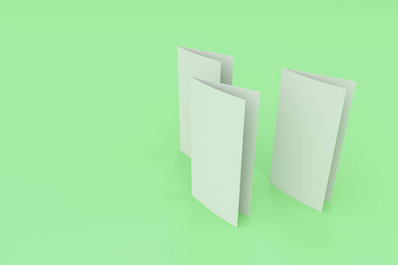 空白的白色两折小册子样机在绿色背景上