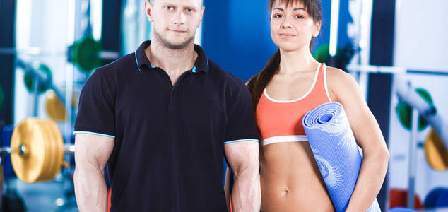 年轻的男人和女人放松在健身房运动服装