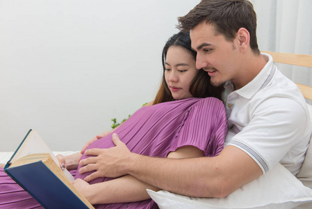 孕妇和她英俊的丈夫读一本书