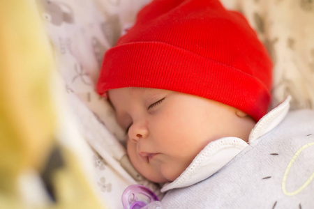 刚出生的婴儿睡在婴儿小推车。特写