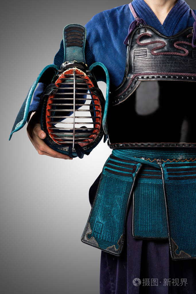 male in tradition kendo armor with shinai (bamboo sword).