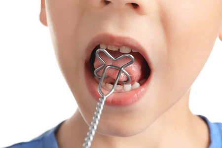 可爱的男孩,用言语矫正探头语音校正在白色的背景下,特写照片