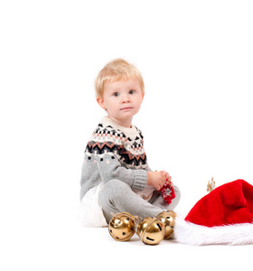 圣诞节装饰品的婴孩女孩和圣诞老人的帽子