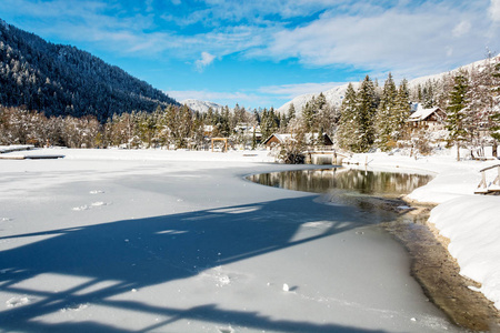 Kranjska 戈拉的冰冻湖亚斯纳马蒂奇和一个阳光明媚的冬日里的塔景