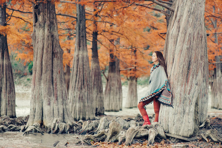波西米亚式女子在秋季公园漫步图片