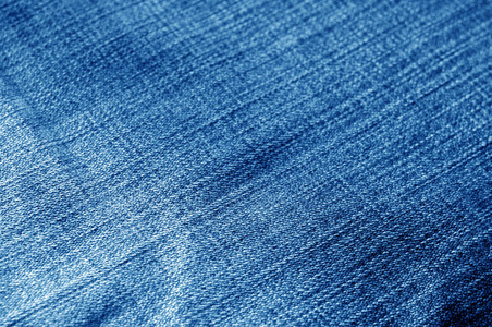 海军蓝颜色牛仔裤布图案具有模糊效果。设计的抽象背景和纹理