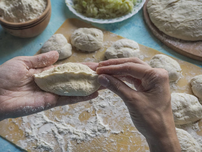 自制蛋糕面团在女性的手。手工制作馅饼与白菜面团的过程