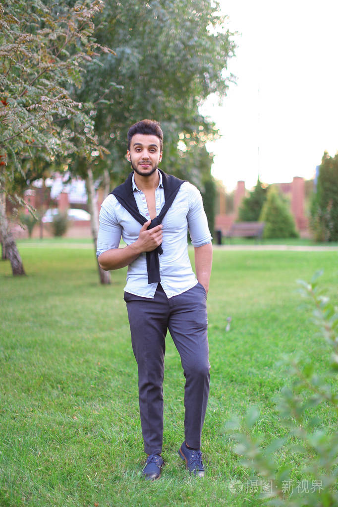 年轻快乐西班牙人在公园散步