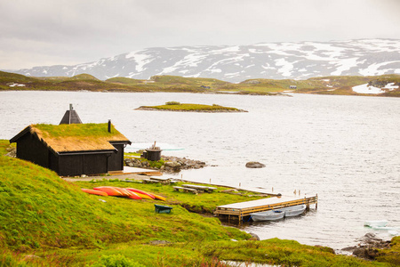 Haukeliseter Fjellstue, 屋顶上长满青草的房子。许多独木舟室外, 挪威湖风景