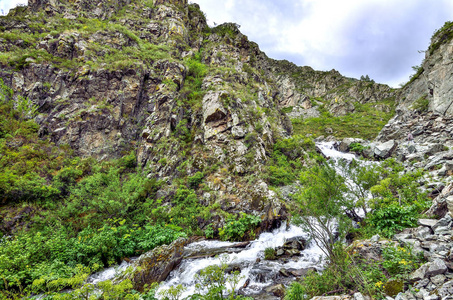 山溪与瀑布下的峭壁在阿尔泰山脉, 俄罗斯美丽的夏季景观