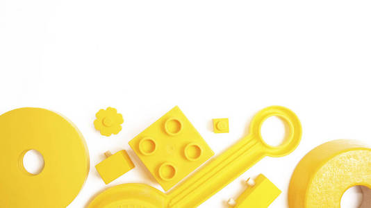 黄色玩具背景白色的顶部视图。儿童玩具框架在白色背景。顶部视图。平躺
