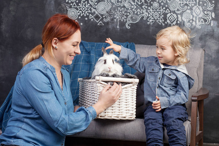 母亲和儿子玩一只白兔