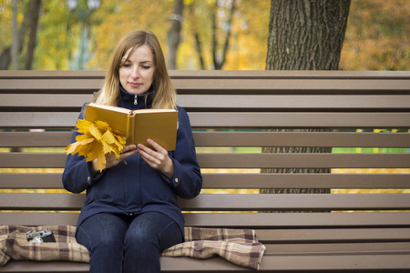 和狗坐在公园长椅上的女孩图片