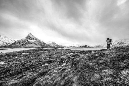 旅行摄影师在罗弗敦群岛拍照。黑白色挪威风景