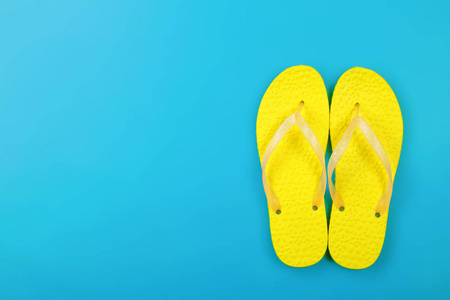 衣服, 鞋和配件. 顶部视图黄色双拖鞋凉鞋在蓝色背景上