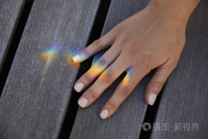 女子手上亮彩虹灯