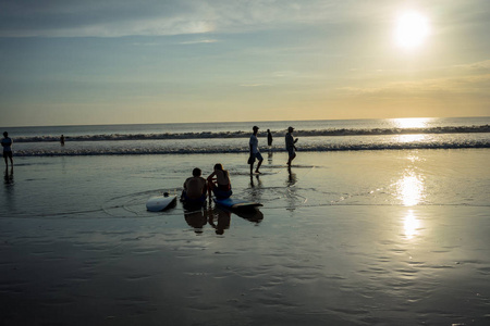 海滩上的人们在水中日落