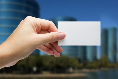 欧美商务名片手拿着白色名片上模糊的背景照片