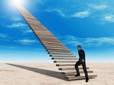走在楼梯上到天堂的商人照片