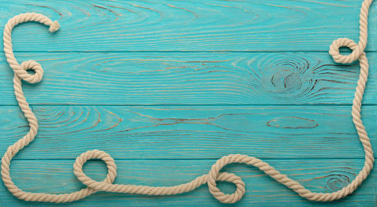 绿松石的木制背景边框和绳子图片