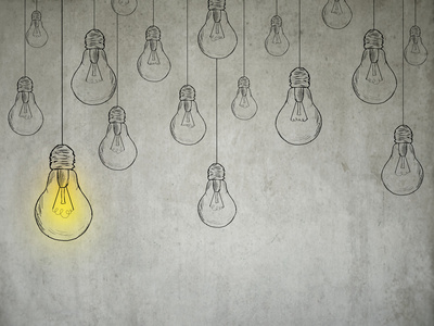 离群值思想理念与灯泡上灰墙背景照片
