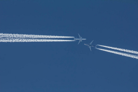 两乘客飞机飞向彼此在蓝蓝的天空